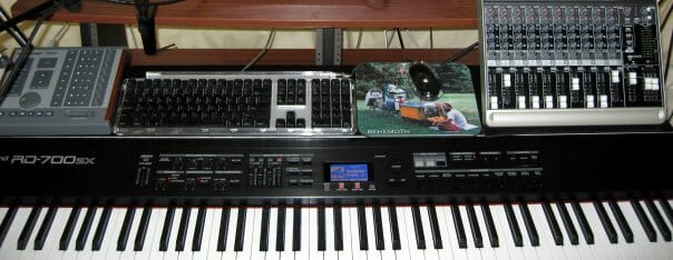 Keyboard shelf loaded with gear